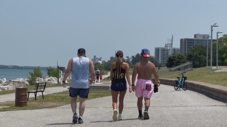 Three people walking on a trail in hot weather