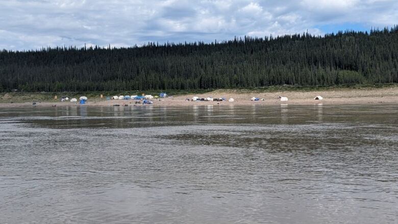 tents on the shore of a river