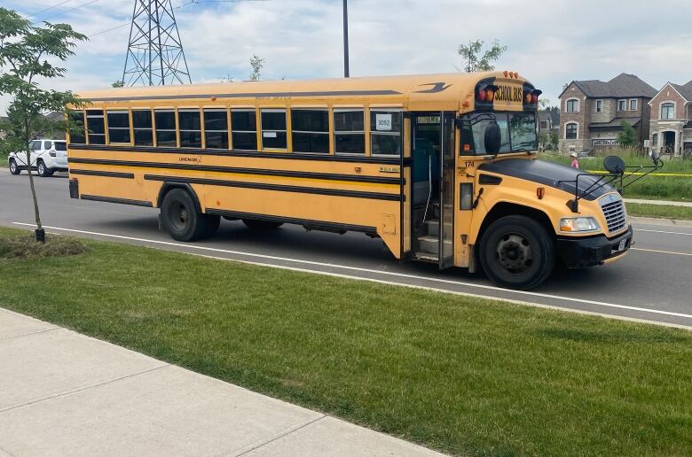 The school bus involved in a fatal collision with a six-year-old boy is parked in the street.