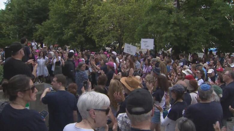 People seen standing at a rally.