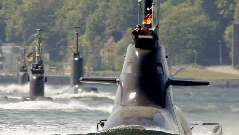 Submarine 'U 34' of the 212A-class of the German Navy, right, leads the four-submarine flotilla passing by the submarine memorial at Heikendorf-Moeltenort at the Baltic Sea, northern Germany, on Friday, May 4, 2007, on the occasion of the 100th anniversary of the 'German submarine.'