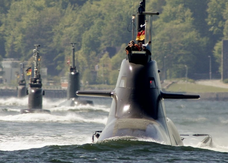 Submarine 'U 34' of the 212A-class of the German Navy, right, leads the four-submarine flotilla passing by the submarine memorial at Heikendorf-Moeltenort at the Baltic Sea, northern Germany, on Friday, May 4, 2007, on the occasion of the 100th anniversary of the 'German submarine.'