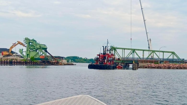 Heavy machinery and a bridge under repair.