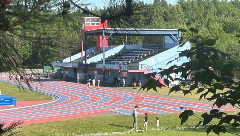 A view of the Laurentian University track stadium through the trees