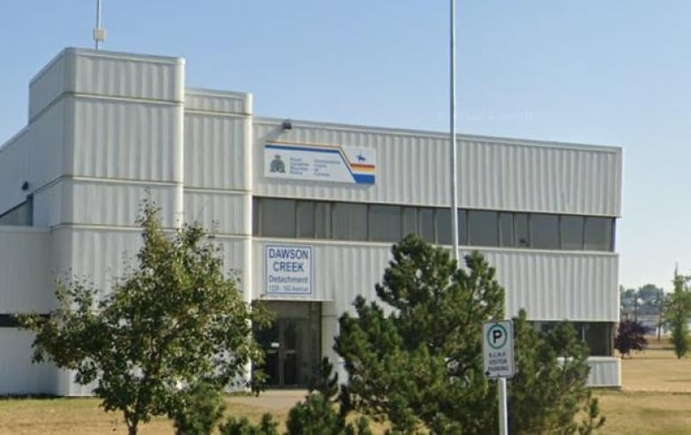 A large white building with the RCMP logo and the words 'Dawson Creek detachment' on it.