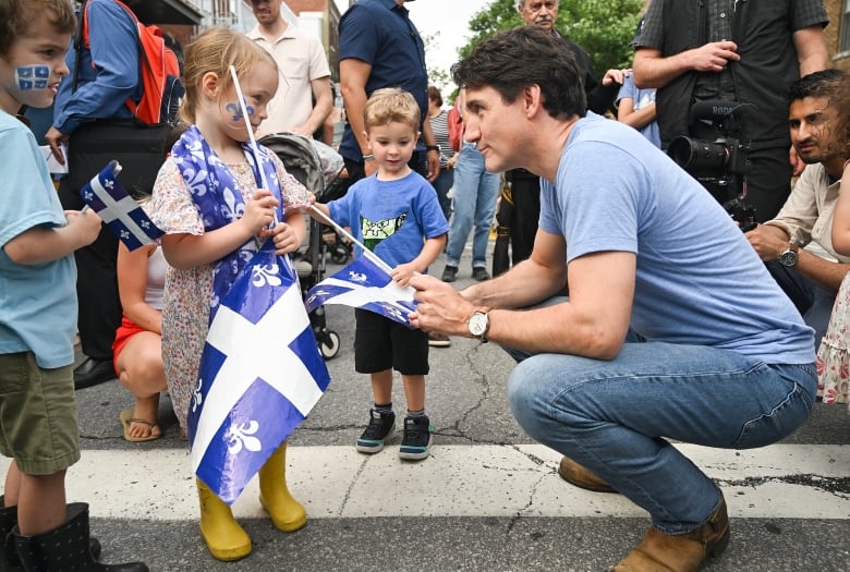 Prime Minister Justin Trudeau talks with children during a Fte nationale event in Montreal on Sunday, June 23, 2024.