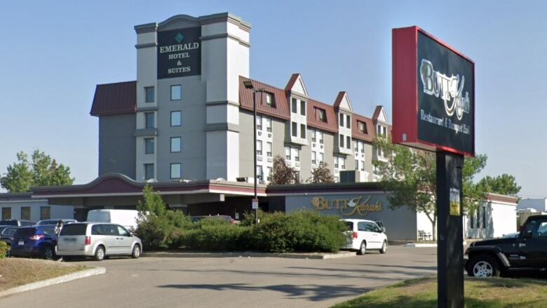 A five-storey hotel is bathed in sunlight.