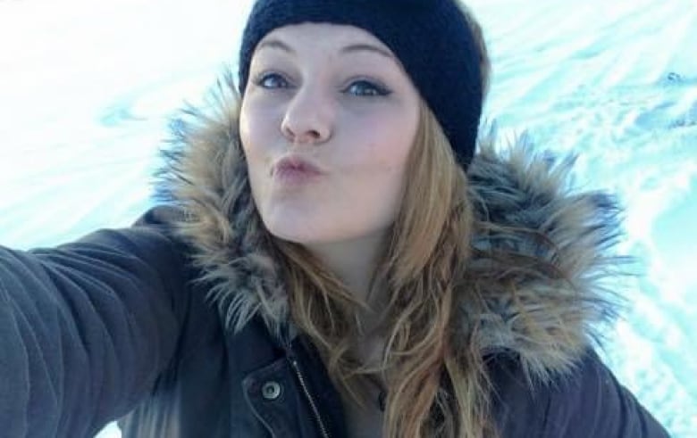 Young woman in parka in the snow.