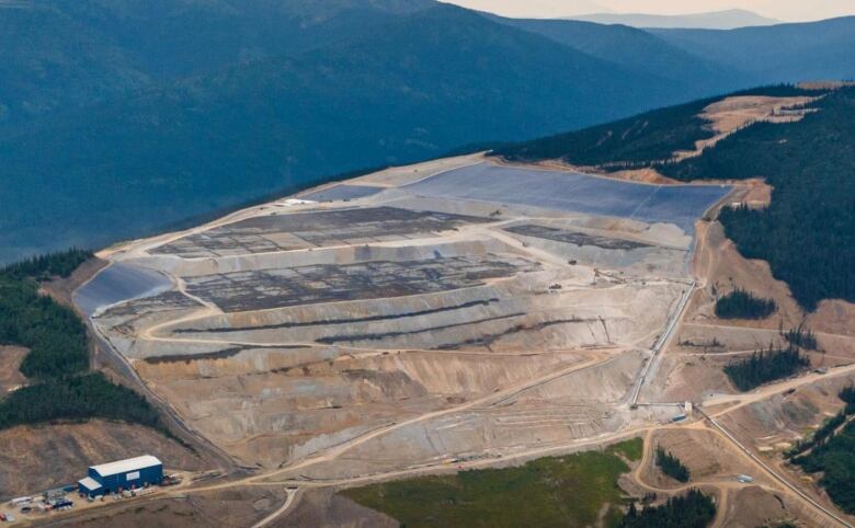 An aerial view of a mine site in the mountains.