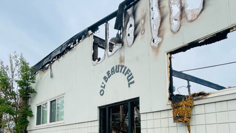 A photo of the burnt facade of a building.