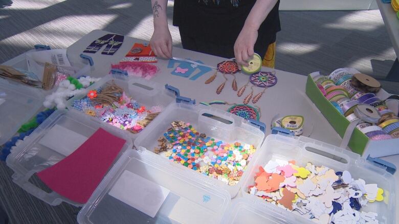 A table with multiple craft materials on boxes.