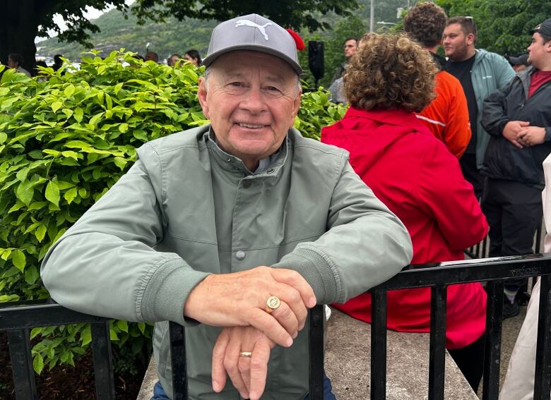 Man in baseball cap and grey coat