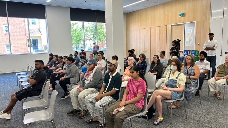 Group of people sitting in a room.