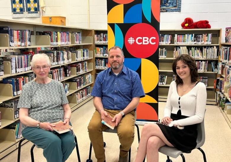 book club members sit and smile at camera