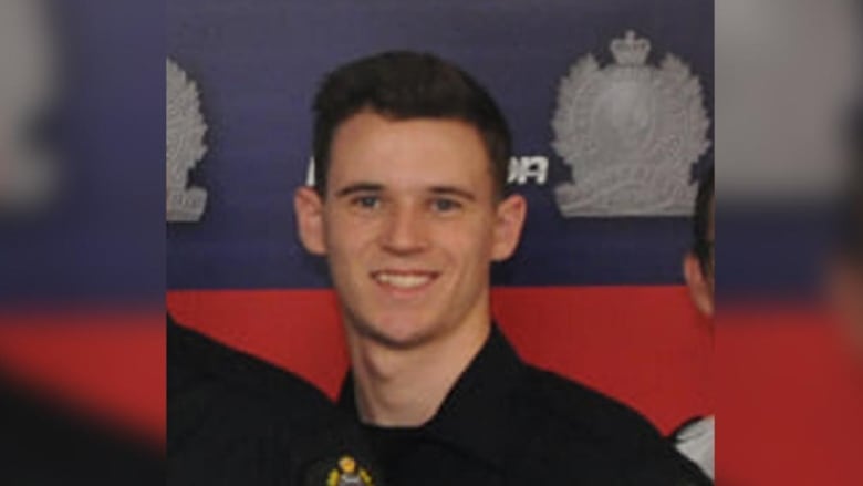 A police officer smiles.