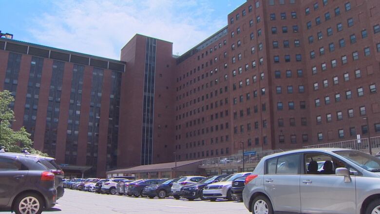 A large brick building with cars parked outside.