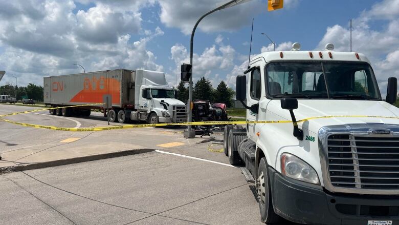 Passenger vehicles and two semi-trucks crashed at an intersection. 