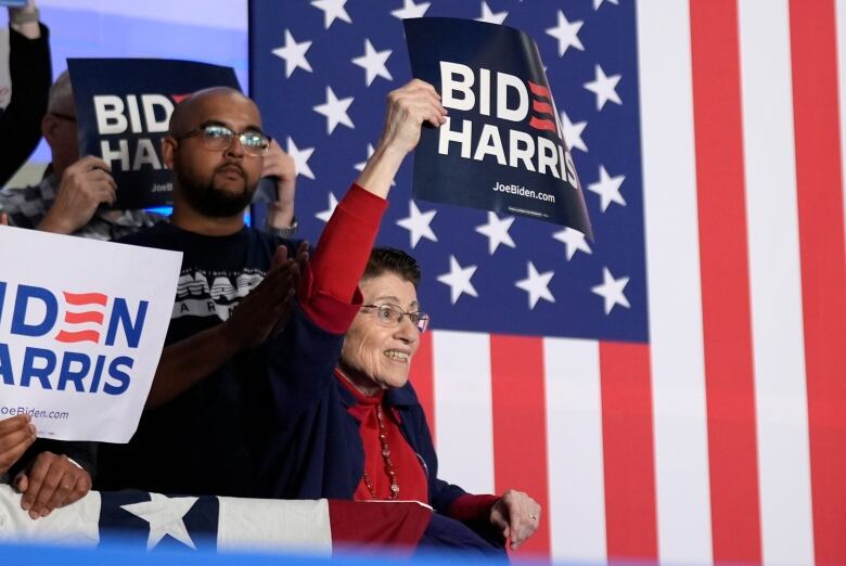 Supporters of U.S. President Joe Biden are seen holding signs at a Wisconsin-held campaign rally on Friday.