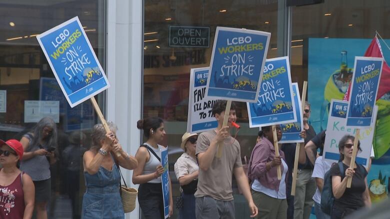 Photograph of workers striking outside an LCBO