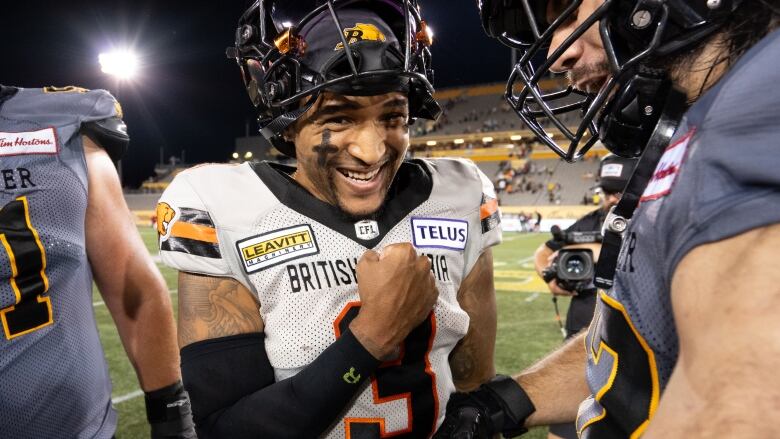 BC Lions quarterback Vernon Adams Jr. pumps his fist. He is a Black man wearing football gear.