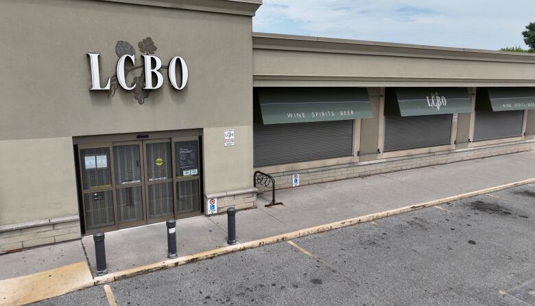 Aerial (Drone) views of closed LCBO - due to strike - in the Junction area. Shows empty parking lot. 