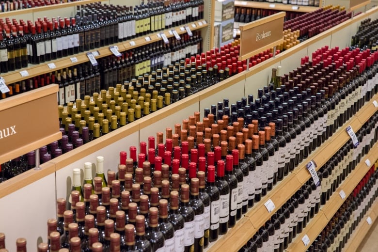 Rows of wine bottles on shelves seen from above, in an LCBO store.  