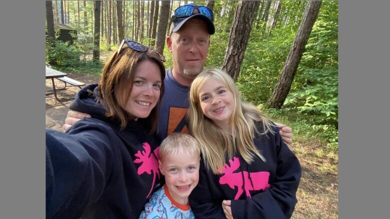 A family of four on camping grounds.