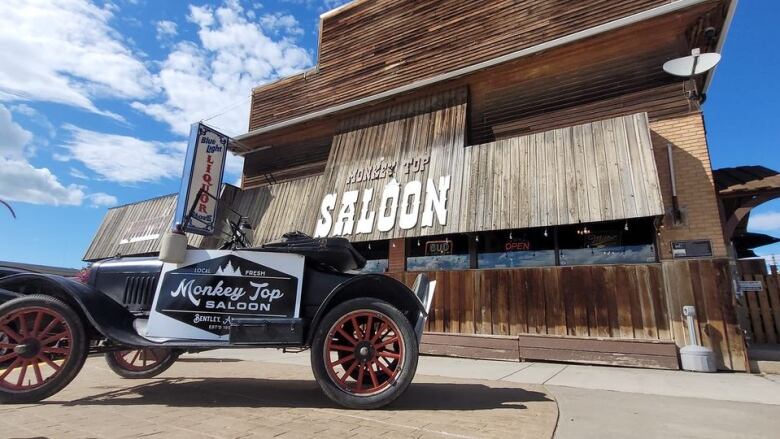 Monkey Top Saloon with old fashioned car in front.