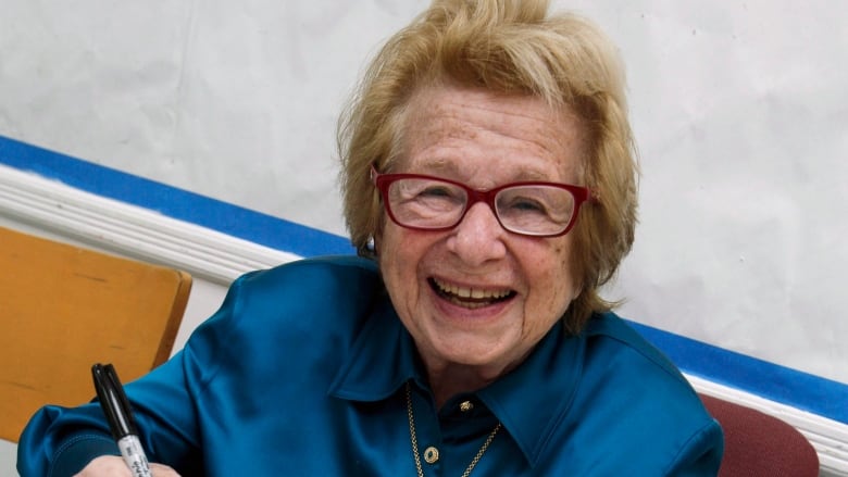 Dr. Ruth Westheimer signs a copy of her book.