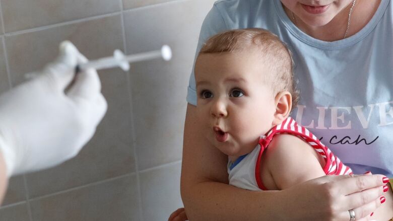 A child reacts before receiving a vaccine injection at a kids clinic in Kiev, Ukraine, in 2019.