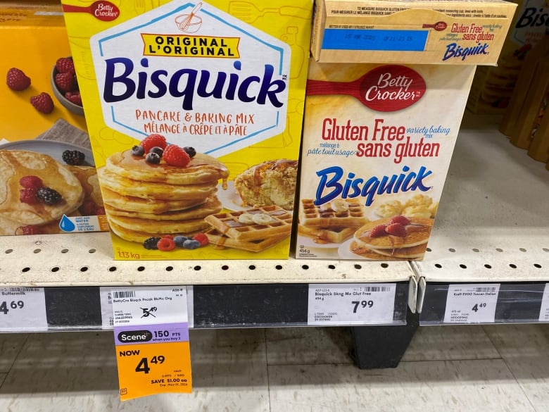 A yellow box of Bisquick pancake mix is on sale for $4.49, sitting beside a white box of gluten-free Bisquick mix for $7.99.