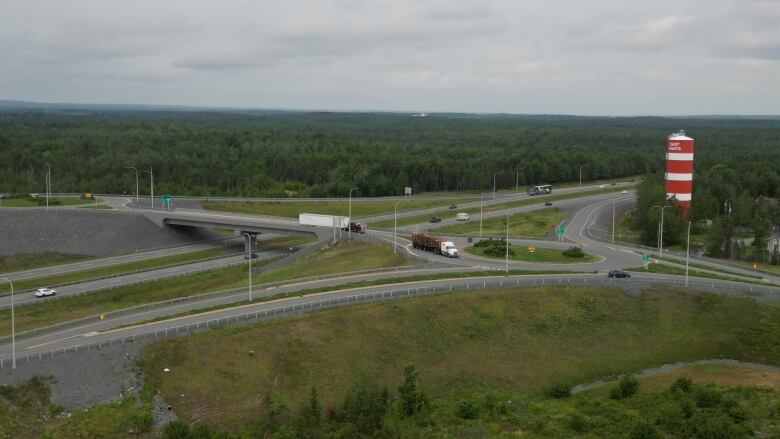 a new highway interchnage, watertower and forested landscape 