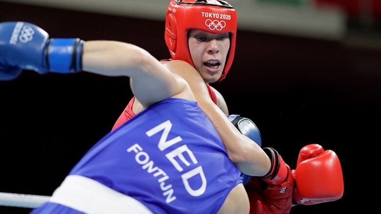 Canadian boxer Tammara Thibeault exchanges punches with Nouchka Fontijn of the Netherlands during the women's 69-75 kg quarterfinal at the Tokyo Olympics on July 31, 2021. 