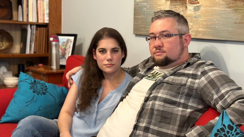 Man and woman sitting on couch