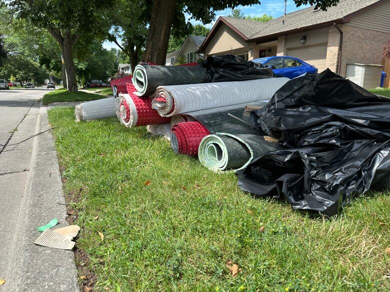 rolled up carpet on lawn