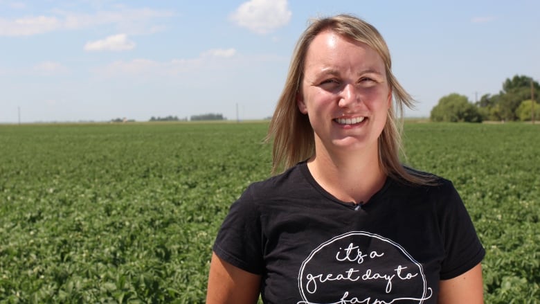 A blonde woman is pictured in front of a potato field wearing a t-shirt that says, 