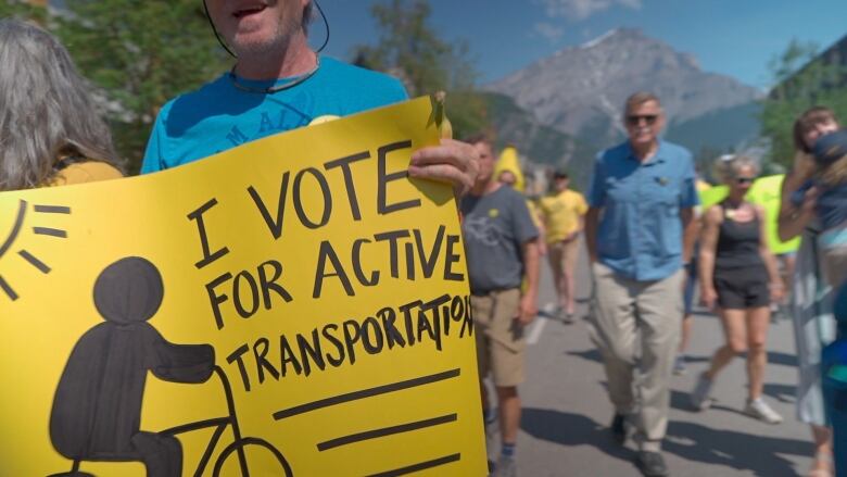 a man holds a sign that says 