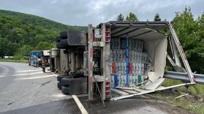 A transport truck that had overturned on a highway. 