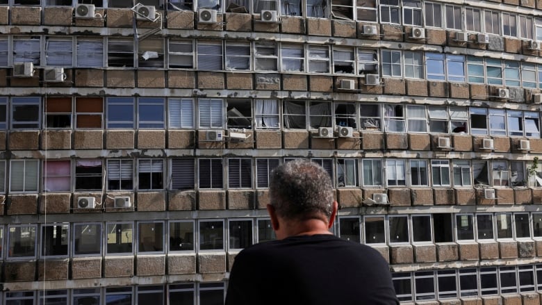 Damaged windows are shown in a closeup of a high-rise building.