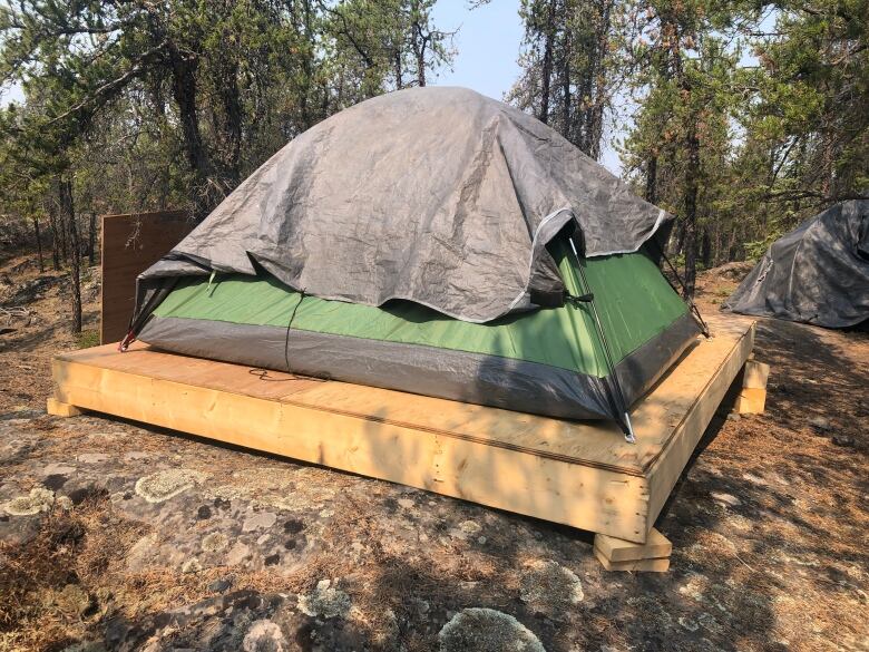 A pop-up tent on a small platform