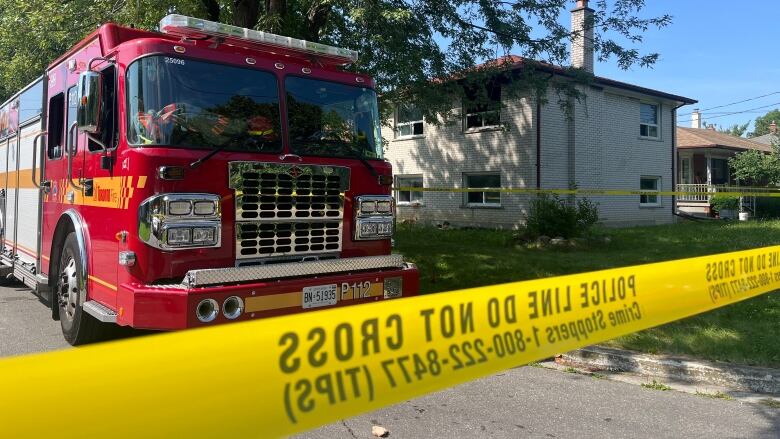 A fire truck is parked outside a house.