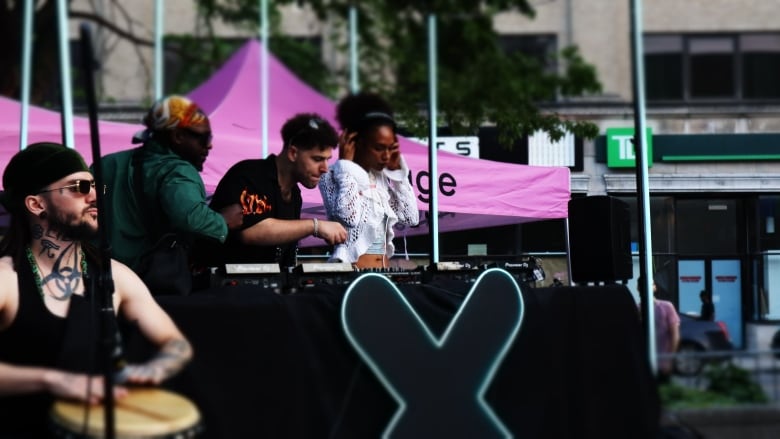 DJs on a stage in Montreal's Village