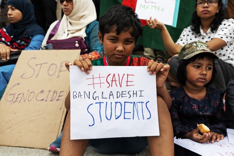 A child holding a sign