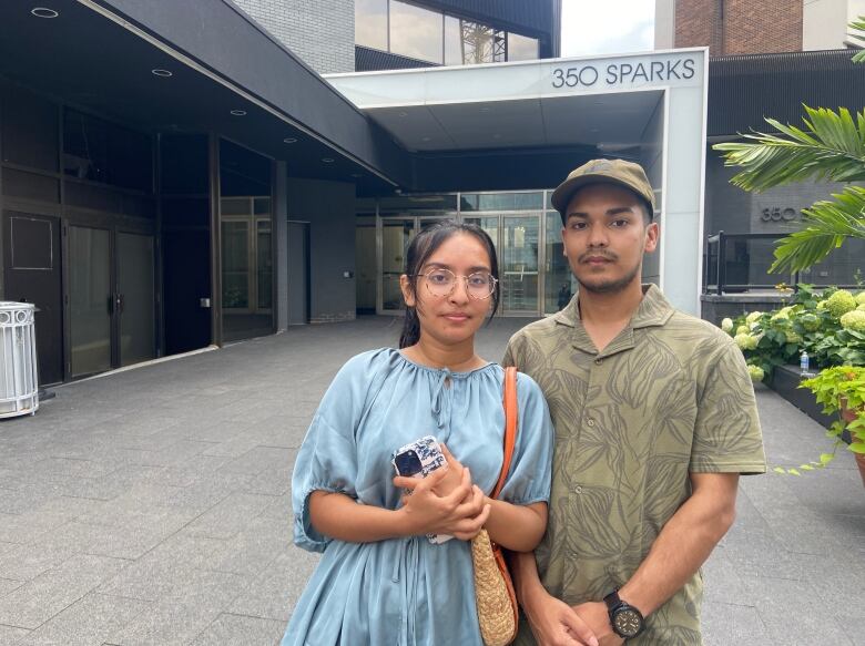 A Bangladeshi-Canadian couple stand outside the Bangladesh High Commission in Ottawa. 