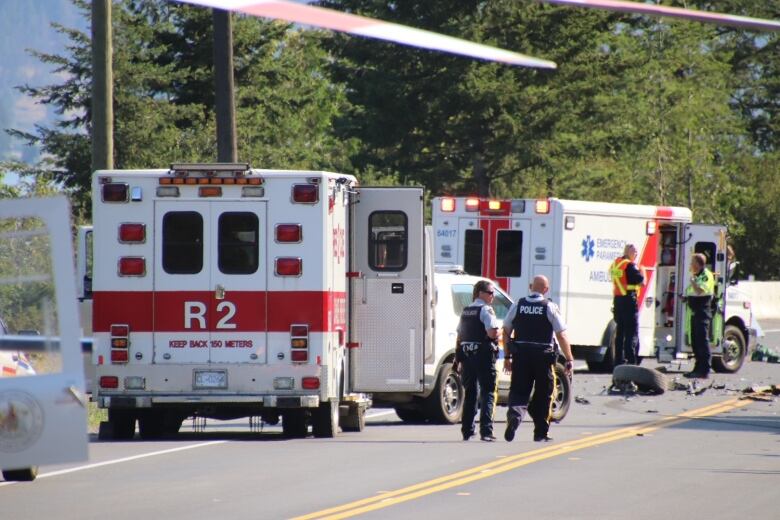 Ambulances and paramedics at a scene of crash in a highway