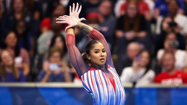 A female gymnast poses