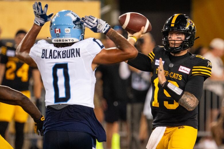 A football player throws a ball.