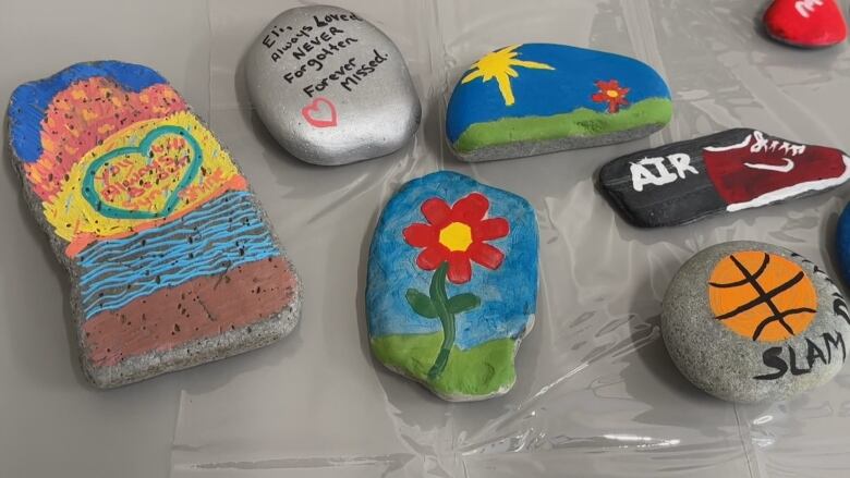 Colourful painted rocks in memory of Eli Young.