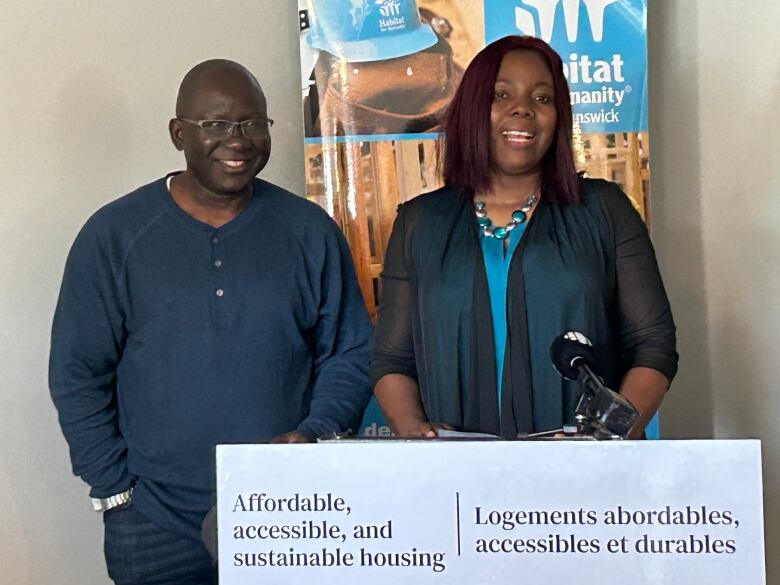 A black couple standing at a podium.