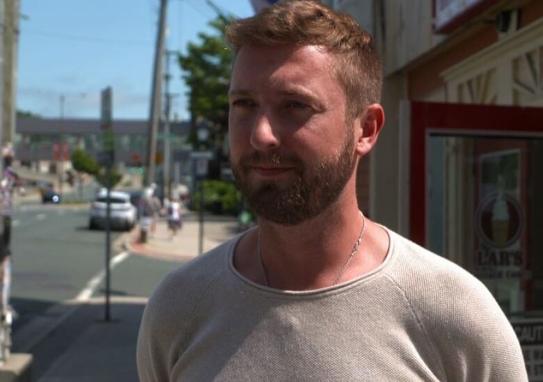 Man standing out side pub he owns.